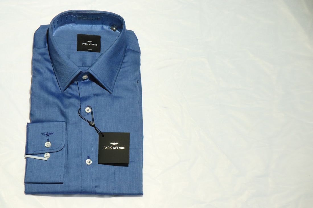 blue polo shirt on white textile