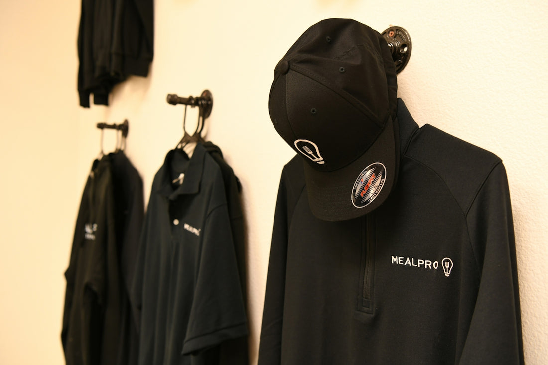 a black jacket hanging on a white wall