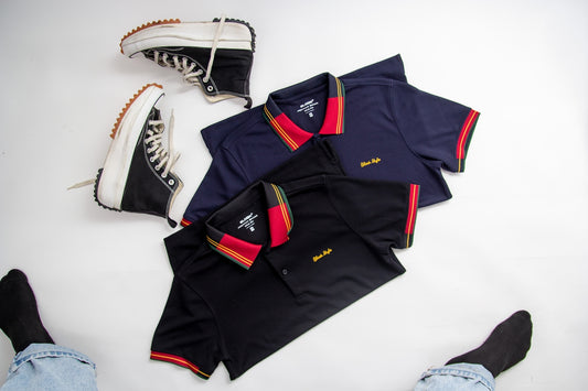 a pair of shoes and a polo shirt on a white surface