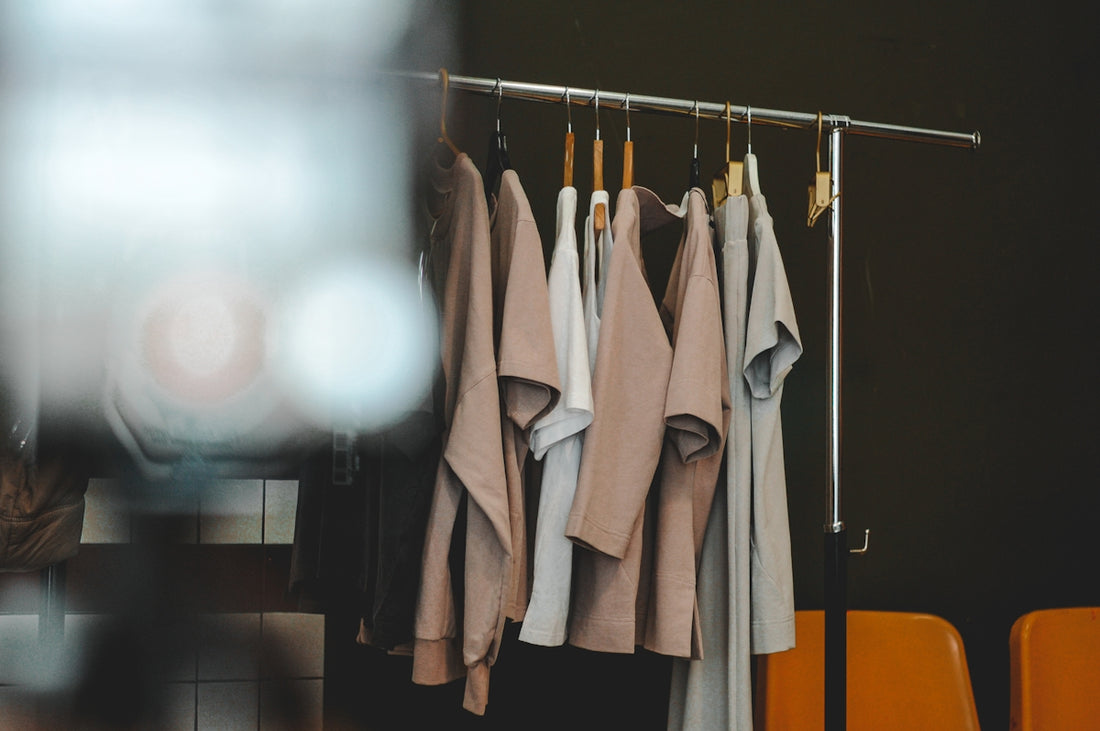 Clothes hang on a rack in a minimalist style.