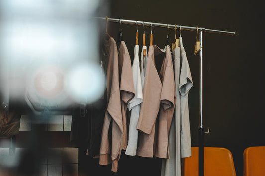 Clothes hang on a rack in a minimalist style.